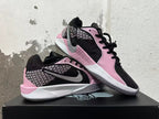 Pair of pink and black low-top basketball shoes shown from side and top angles.