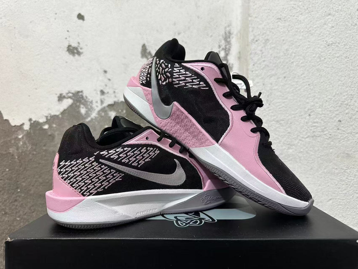 Pair of pink and black low-top basketball shoes shown from side and top angles.