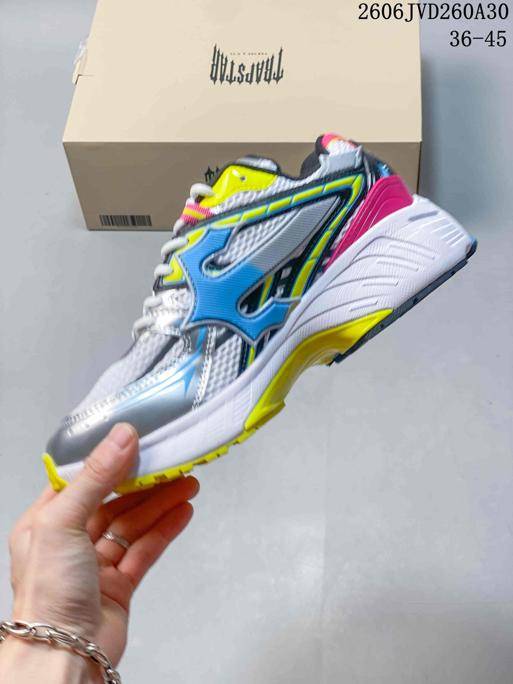 Side view of the sneaker with blue, neon yellow, and pink details