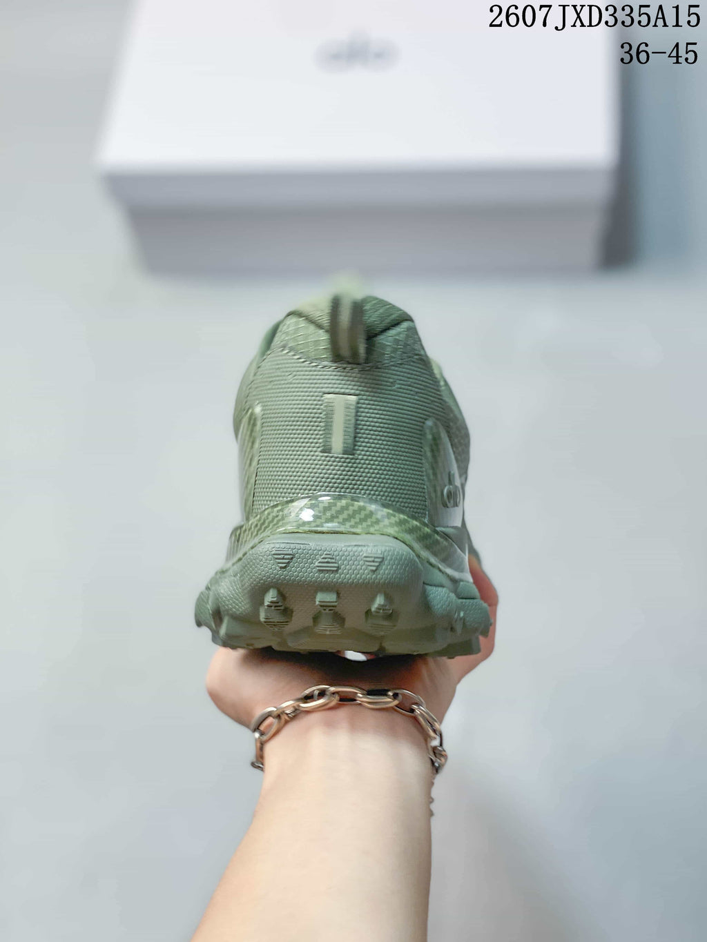 Rear view of the green sneaker showing the padded heel area, pull tab, and textured outsole.