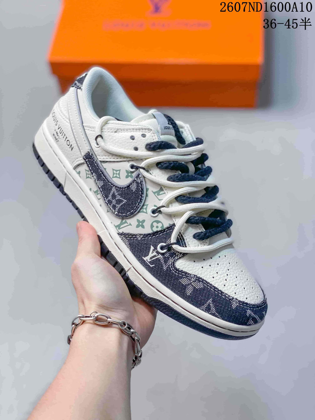Angled side view highlighting the white and navy low-top construction, patterned side panels, rope-style laces, and visible branding.