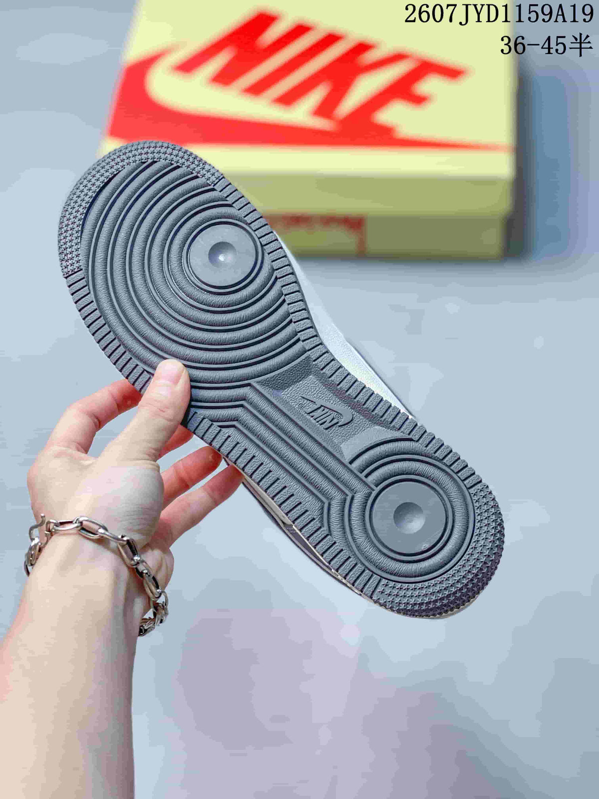 Close view of the sneaker outsole showing concentric circular traction patterns and a textured perimeter.