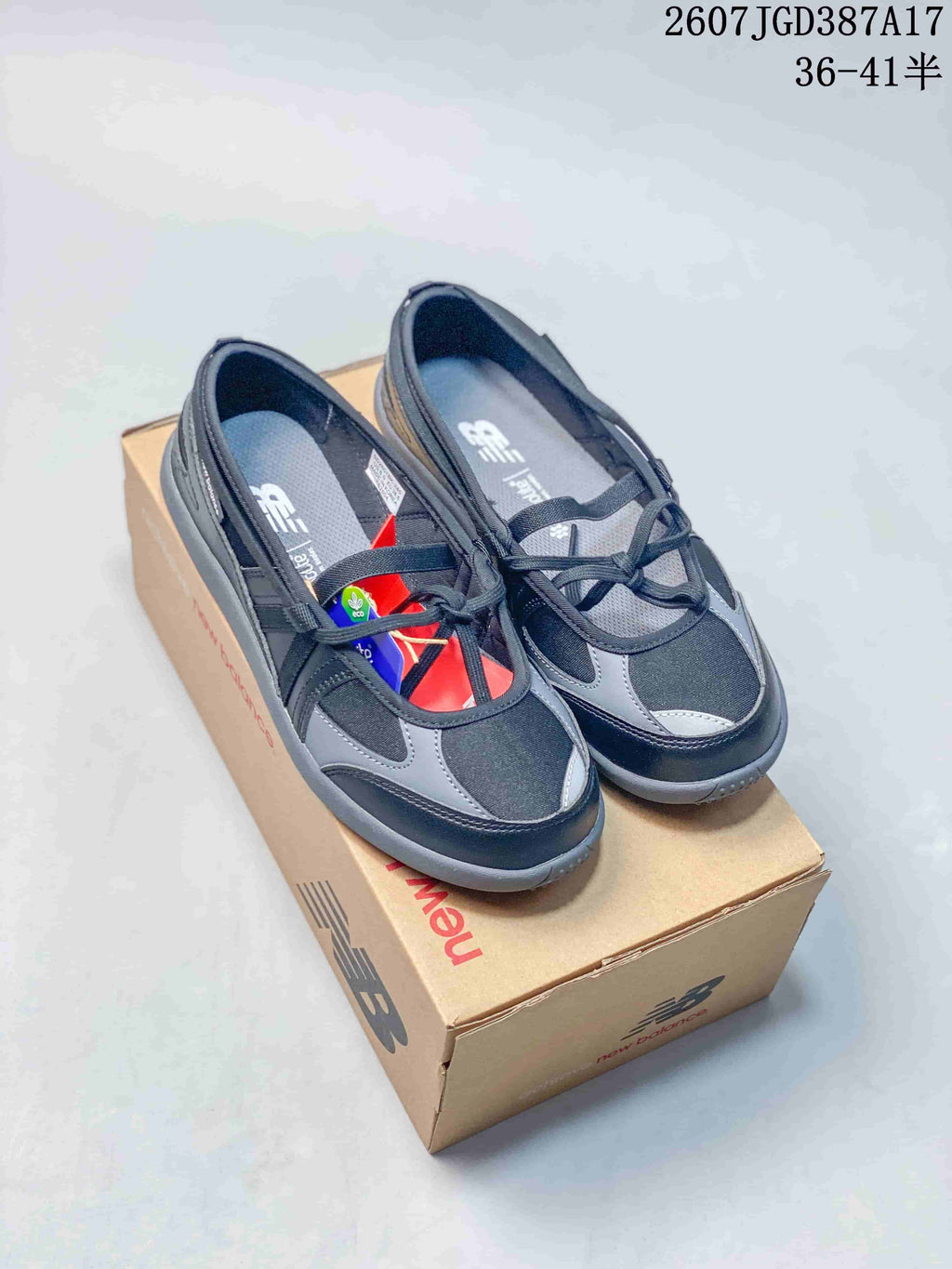 Pair of black and gray New Balance low-top sneakers displayed on a shoebox.