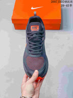 Top view of the sneaker showing the mesh tongue, laces, orange toe details, and tongue label reading Zoom Winflo 9X.