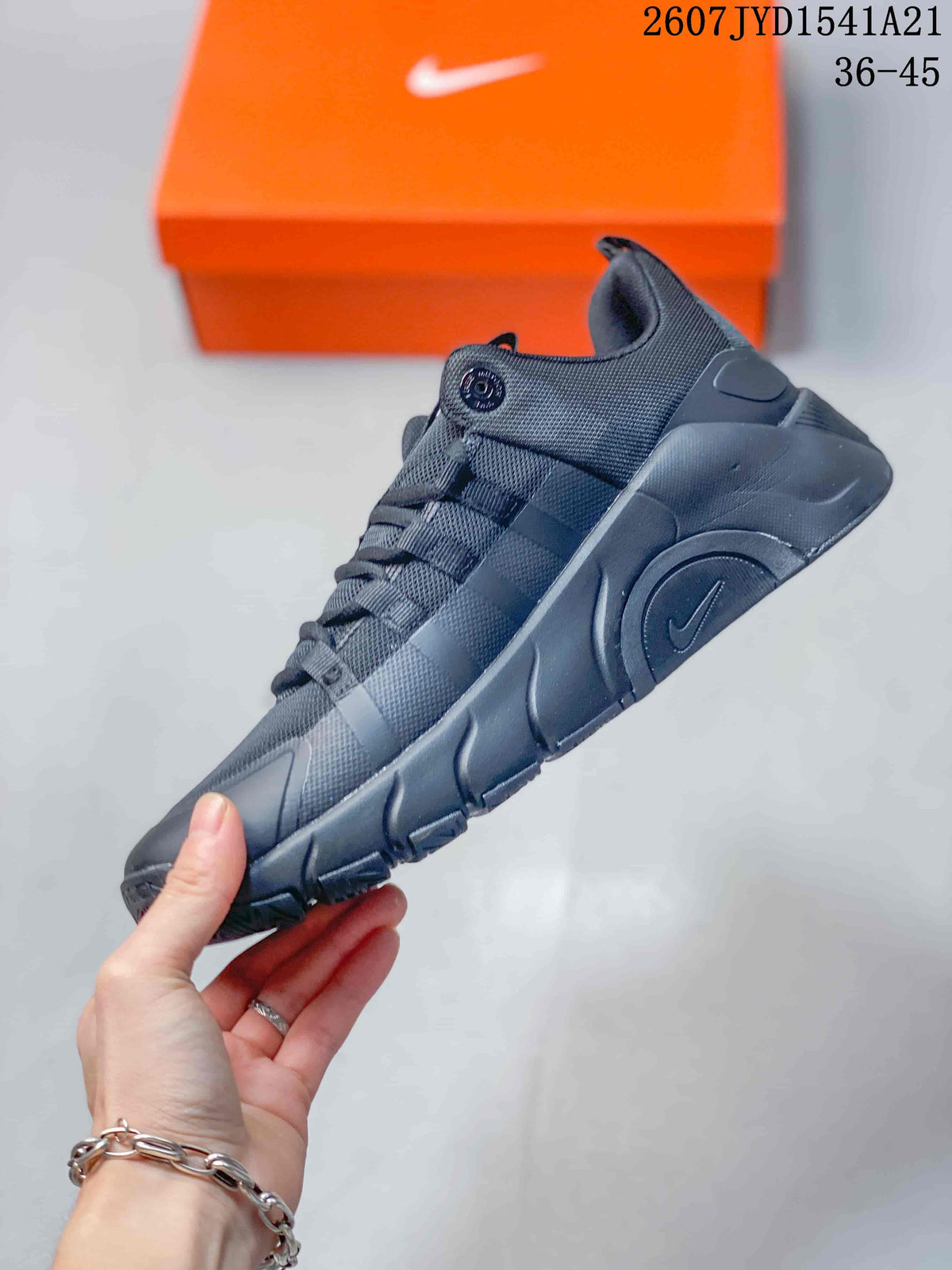 Side profile of the black sneaker showing the layered upper and molded sole.