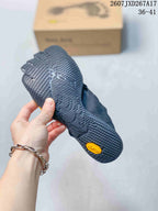 Close-up of the textured black outsole with a yellow Vibram badge.