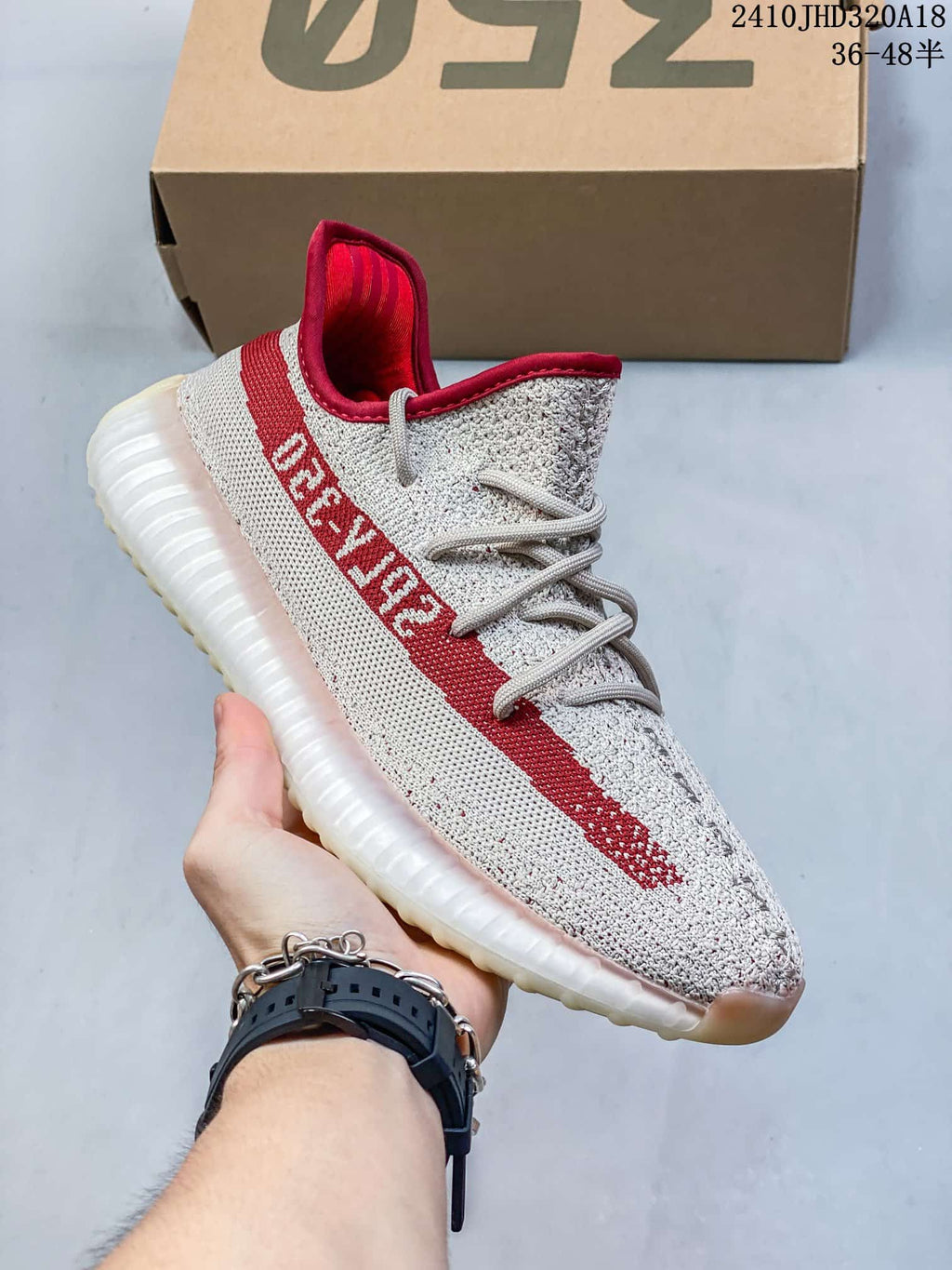 Angled side view showing the red side stripe, knit upper, and translucent sole.
