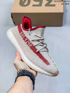 Angled side view showing the red side stripe, knit upper, and translucent sole.
