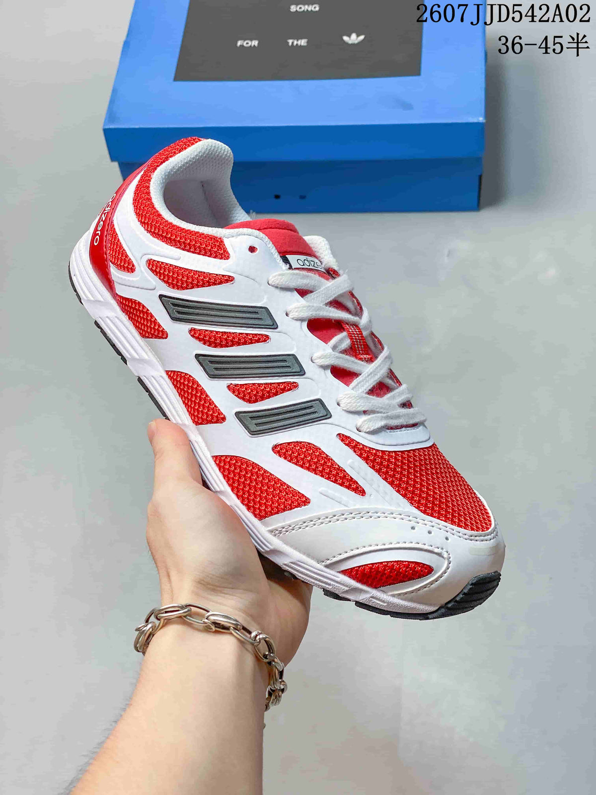 White and red low-profile sneaker with white laces and dark side accents