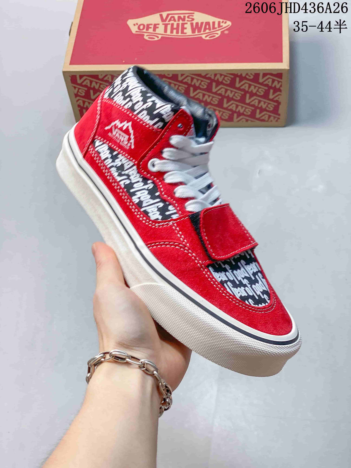 Side view of a red Fear of God x Vans sneaker showing its printed panels and overlay strap.