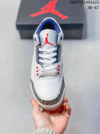 Top view showing white laces, red tongue branding, blue eyestay details, and elephant-print side panels.