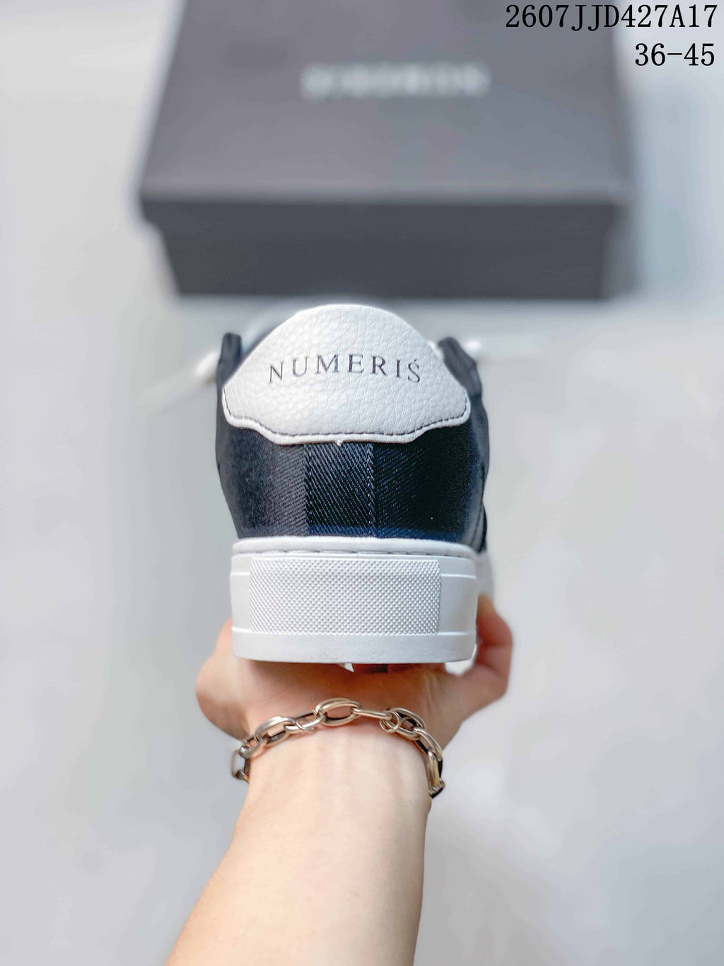 Rear view of the navy and white sneaker showing the NUMERIS heel branding and white heel panel.