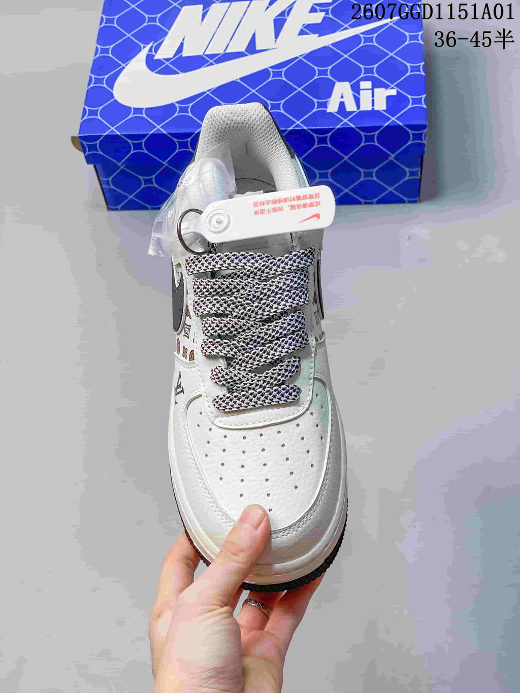Front view of the white perforated toe and patterned laces.