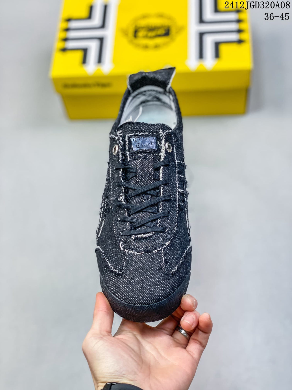 Top view showing the dark blue canvas-style upper, black laces, tongue, and contrasting stitching.