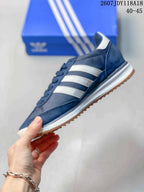 Side profile of the navy sneaker with white three-stripe detailing, white midsole, and gum-colored outsole.