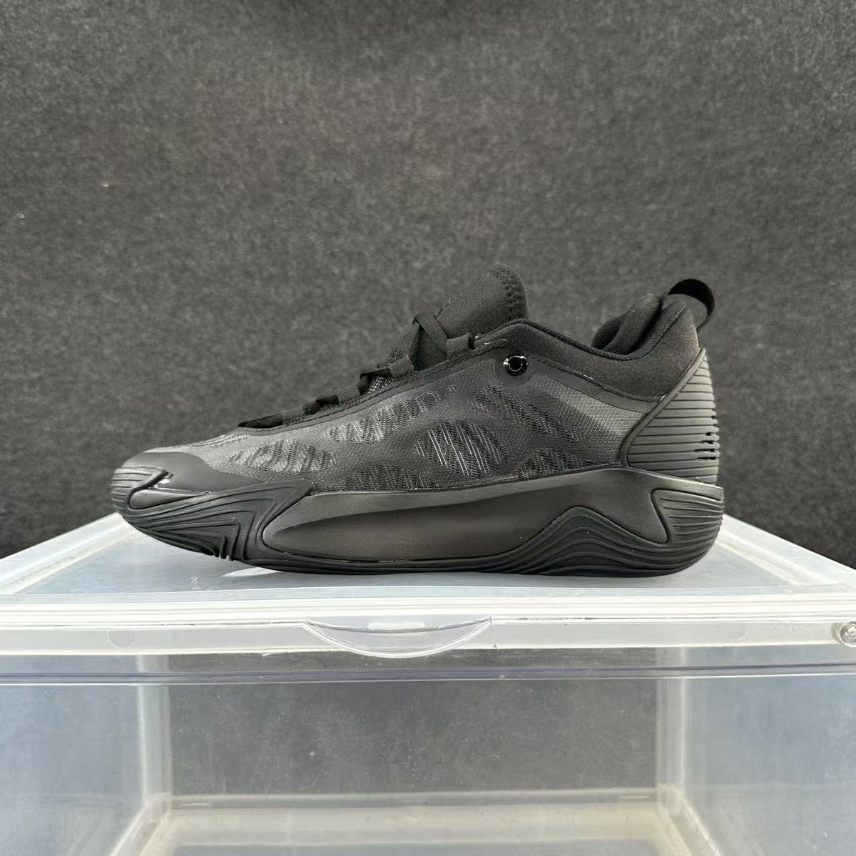 Charcoal gray low-top basketball shoe with a tonal sculpted sole