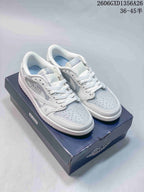 Pair of white and light-grey Jordan low-top sneakers on a shoe box