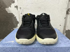 Front view of black Nike basketball shoes with mesh uppers and pale soles