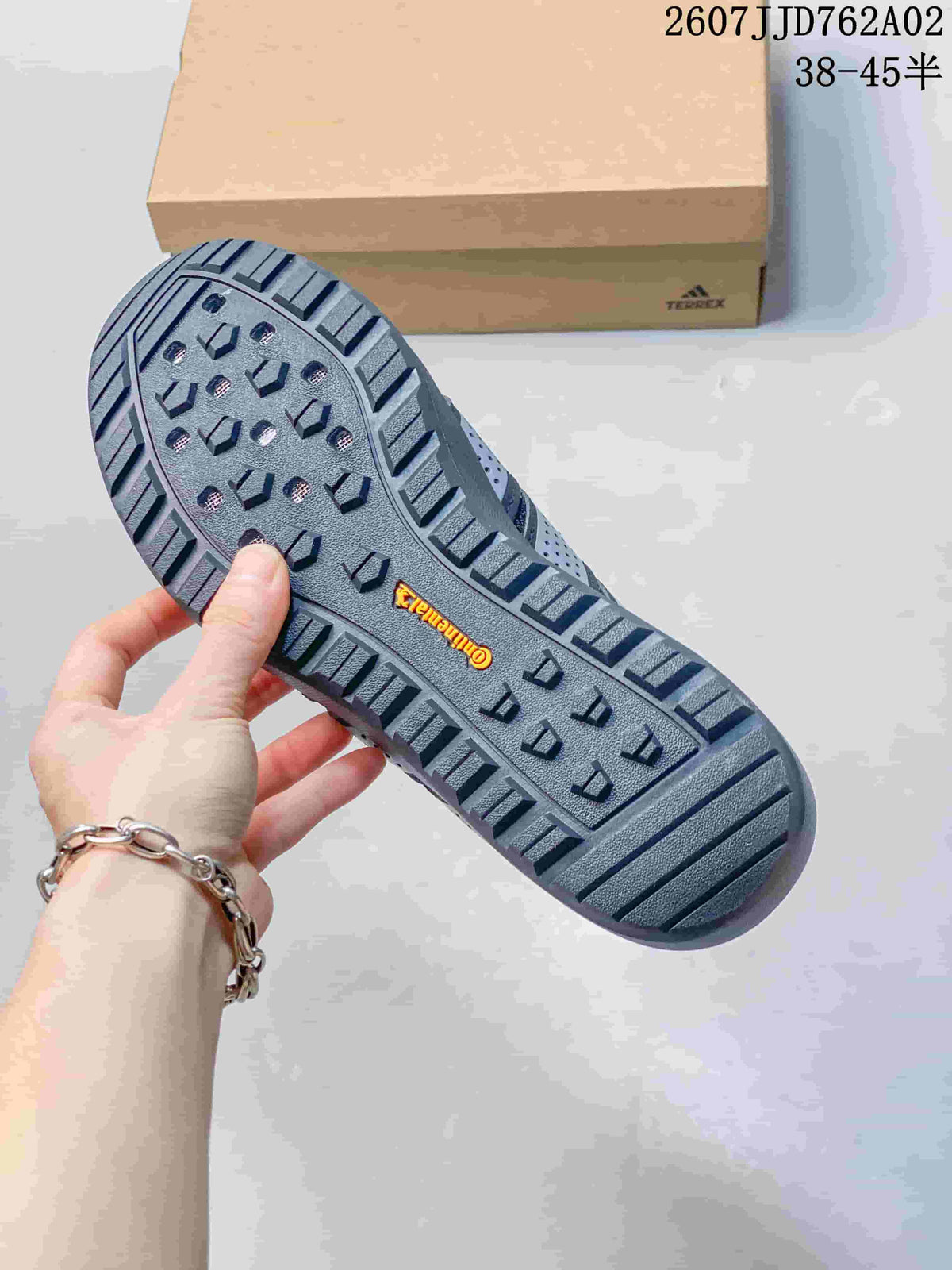 Close-up of the lugged outsole on a charcoal grey outdoor shoe.