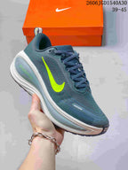 Blue-green Nike Vomero Plus running shoe with a neon yellow Swoosh.