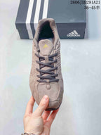 Top view showing the dark laces, tongue branding and rounded toe shape.