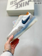 Side view of the Nike SB PS8 sneaker showing the dark Nike Swoosh, white upper, patterned overlays and translucent sole.