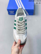 Top view of the sneaker showing the lace-up construction, green adidas tongue label, and white and green color blocking.