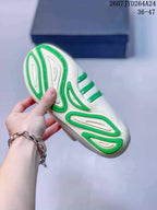 Close view of the shoe outsole showing green and off-white molded sections with Virginia lettering.