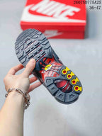 Underside view of a black Nike Air Max Plus TN sneaker showing the patterned outsole with yellow and red details; overlay text shows code 2607ND775A25 and size range 36–47.