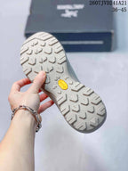 Close view of the lugged outsole with a visible Vibram logo and geometric traction pattern.