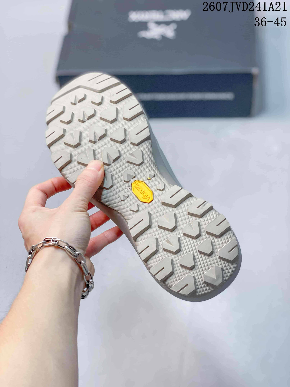 Close view of the lugged outsole with a visible Vibram logo and geometric traction pattern.