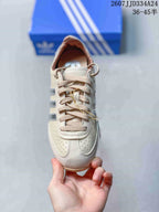 Top view showing the perforated toe box, beige laces, and cream upper.