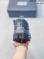 Rear view of the dark gray trail shoe showing the padded heel structure and lugged outsole.