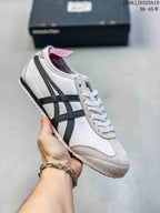 White low-top sneaker with black side stripes and light gray overlays