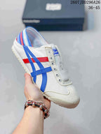 White Onitsuka Tiger Mexico 66 slip-on sneaker with blue and red side stripes and a multicolor striped heel.