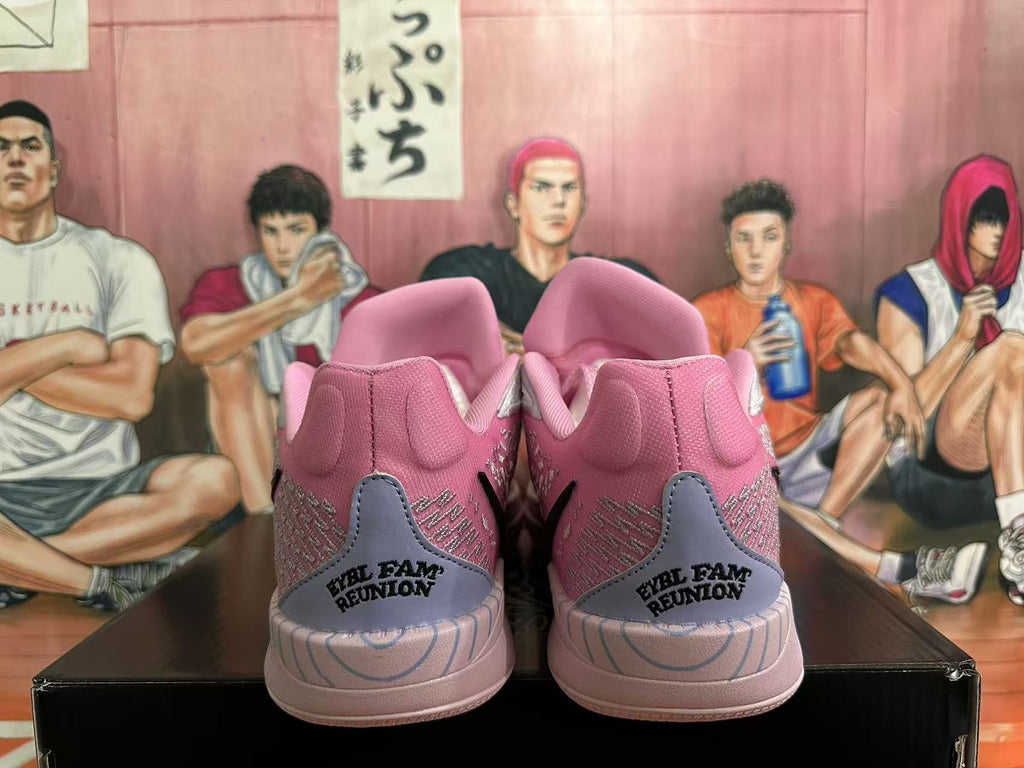 Heel view of pink basketball shoes with gray heel panels and reunion lettering.