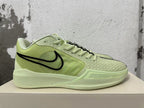 Side profile of a pale yellow-green Nike basketball shoe with a black Swoosh and Zoom-branded sole