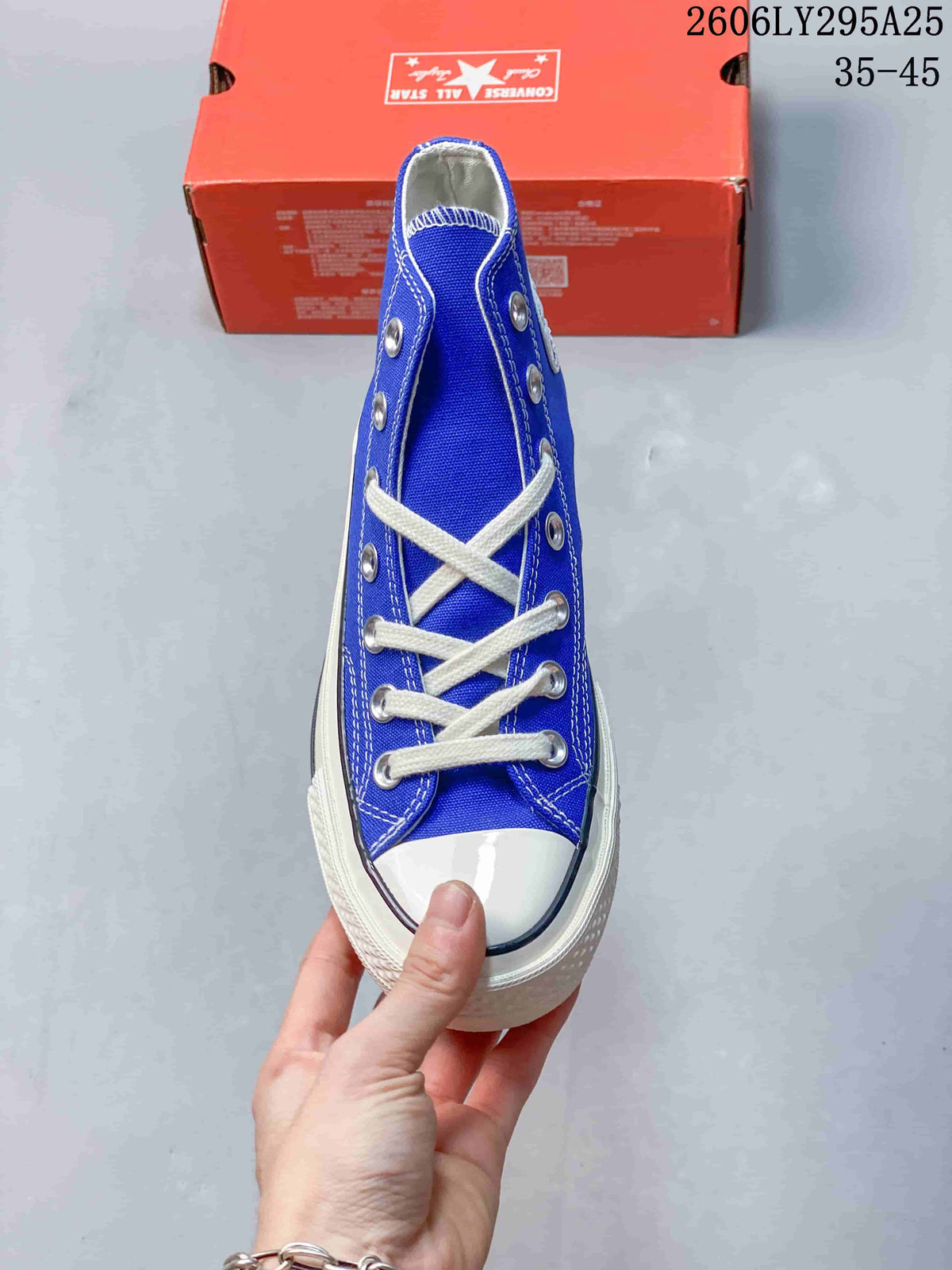 Top view showing the blue upper, white laces, silver eyelets, rubber toe cap, and contrast sidewall stripe.