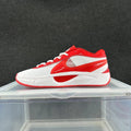 Side view of a red and white low-top Nike sneaker with white laces and a sculpted midsole.