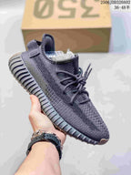 Dark gray knit sneaker with tonal side detailing, dark laces, and a ribbed sole; a size label is visible inside the shoe.