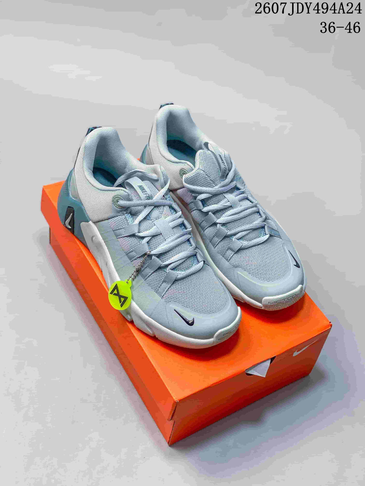 Pair of light gray and blue Nike Free Metcon 6 sneakers displayed on an orange shoebox.