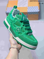 Three-quarter view of the green sneaker showing the mesh toe and side panels, branded side detail and white midsole.