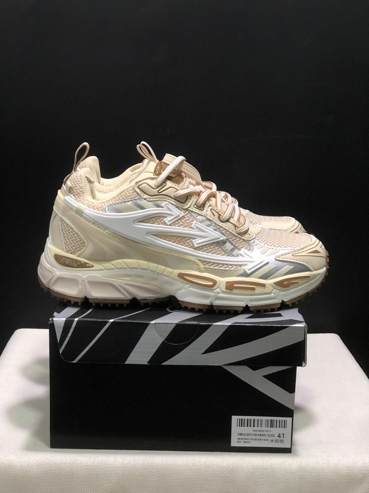 Side view of cream OFF-WHITE Be Right Back sneakers with layered panels, arrow detailing, and chunky soles.