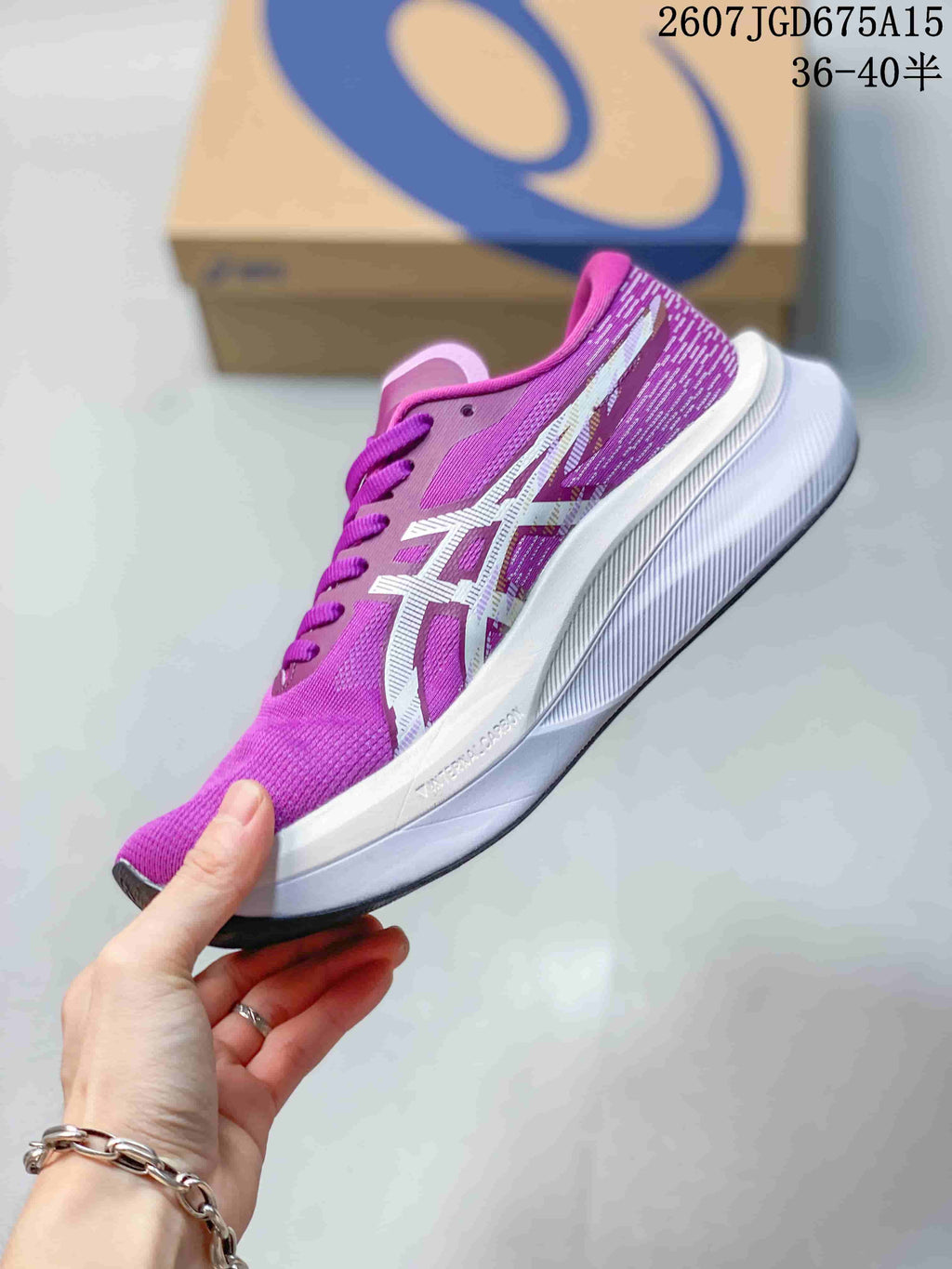 Side profile of the purple ASICS running shoe with white branding and a layered white midsole.