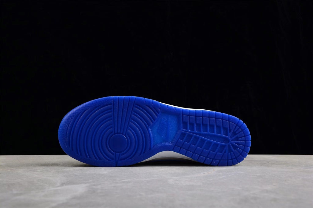 Blue rubber outsole shown from below with circular and grid traction patterns.