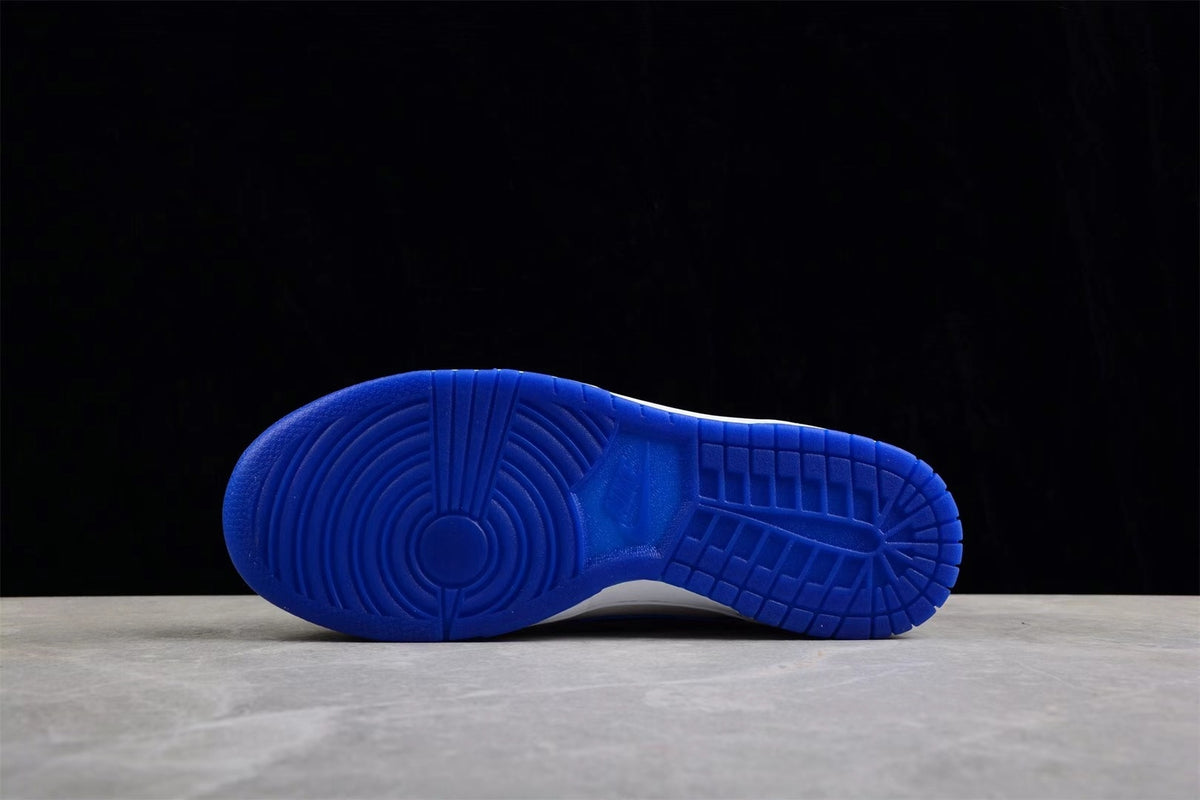 Blue rubber outsole shown from below with circular and grid traction patterns.