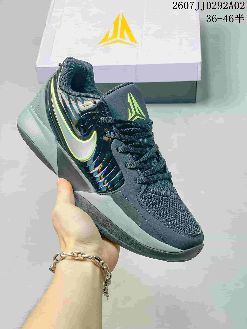 Dark grey Nike JA 2 basketball shoe with a bright outlined Swoosh and reflective side panel.