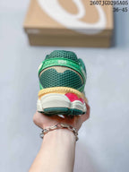 Rear view of the sneaker showing the padded green heel area, layered midsole and dark outsole sections.