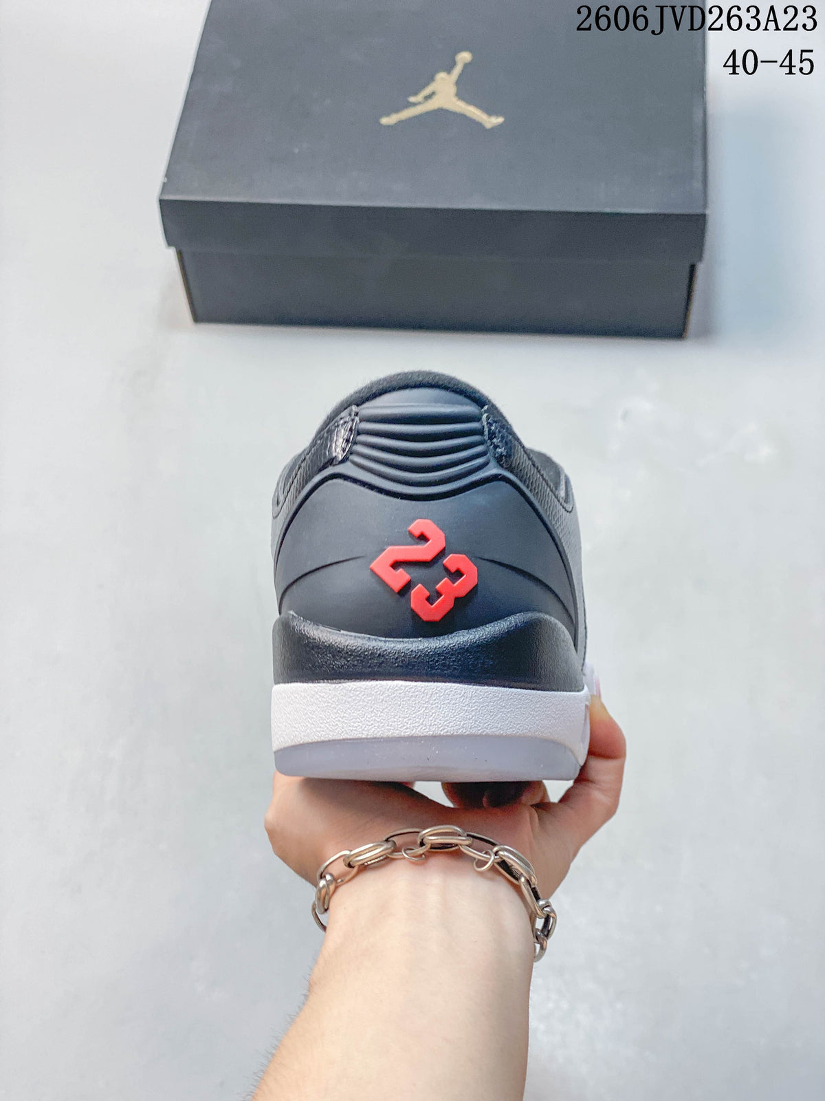 Rear view showing red number detailing, dark gray upper, and white midsole