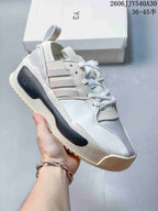 White Y-3 Rivalry sneaker with gray side stripes and a dark heel detail.